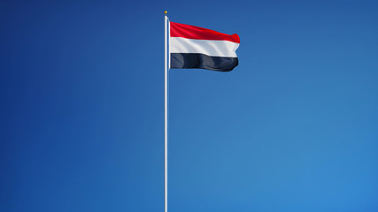 Yemen flag waving against clean blue sky, long shot, isolated with clipping path mask alpha channel transparency