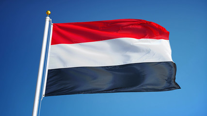 Yemen flag waving against clean blue sky, close up, isolated with clipping path mask alpha channel transparency