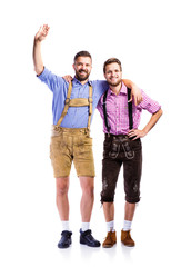 Two hipster men in traditional bavarian clothes, studio shot