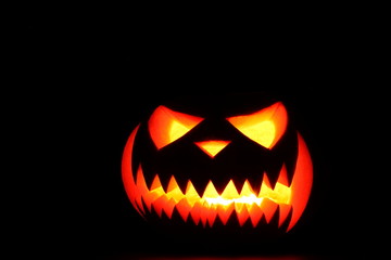 Halloween pumpkin shiny inside on black