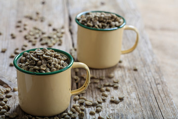Green coffee beans in two cups