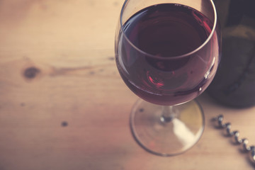Glass of red wine on a wooden background