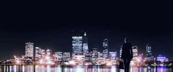 Businesswoman viewing night glowing city