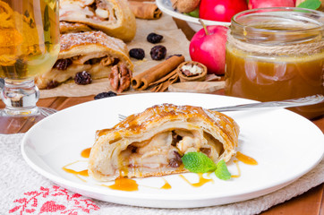 Puff pastry strudel with apples , cinnamon , raisins and walnuts