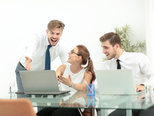 Successful business team with arms up at the office