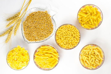 Five types of pasta in glass plates. Grains of wheat 