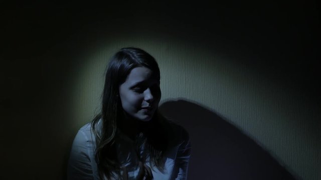 Scared teen girl in a dark. 4K UHD.