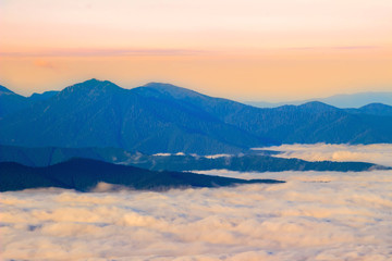 Picturesque sunrise morning in mountains above clouds, Carpathians, Ukraine.
