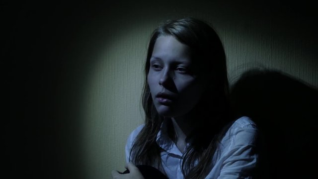 Scared teen girl in a dark. 4K UHD.