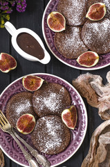 Chocolate pancakes with chocolate sauce and figs   