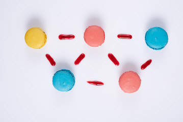 Five multicolored macaroon on a white background from above