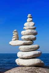 Fototapeta na wymiar Balance and poise stones against the sea. White Rock zen on the