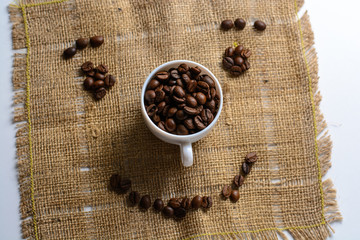 Coffee beans are scattered on the sacking in the form of smiley