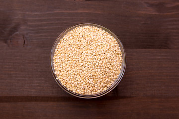 Bowl with quinoa on a wooden table top view