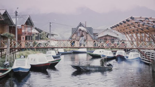 LAKE COCHA, COLOMBIA - CIRCA MAY 2016: Military boat starting a supervision of the Cocha Lake on the beautiful pier of this town. Slow motion