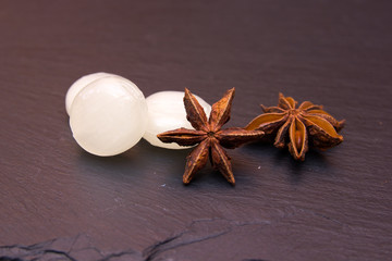 Some candies star anise on a slate floor close views