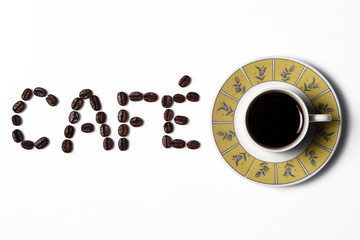 Coffee in the cup with coffee beans around