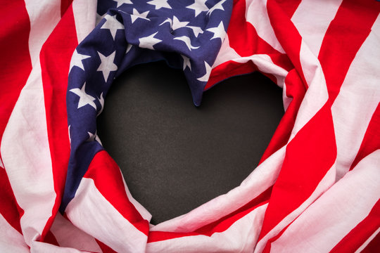 Heart shape American flag on black background .
