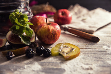 Colorful fruit salad in a jar on rustic wooden background