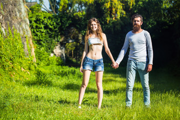 Naklejka na ściany i meble sexy young couple on green grass