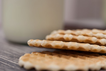 Fluted sweet biscuits and a bottle of milk