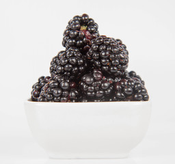 Blackberries: a bowl of fruit on white background