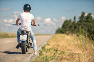 Obraz na płótnie Canvas Young man sitting on his motorbike