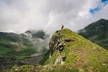 Tourist standing on the edge of the hill and admire the scenery in Romania