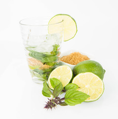 Mojito in a glass and ingredients on a white background