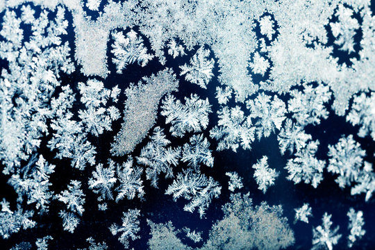 Ice flowers on glass - texture and background