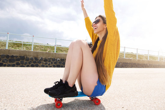 Happy Woman Riding Skateboard