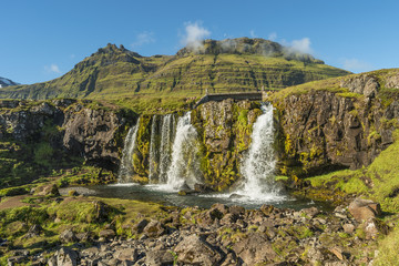 Obraz premium Wonderful waterfal Kirkjufellsfossl in Iceland, summer time