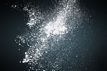 Abstract white powder against dark background