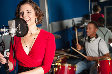 Female singer recording a track in a studio