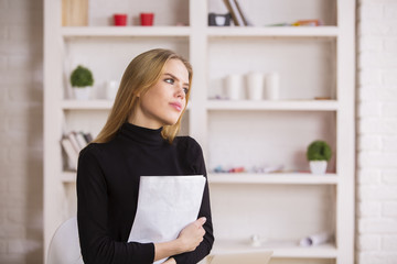 Female daydreaming in office