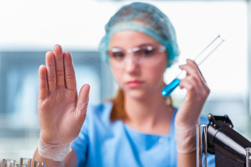 Young student working with chemical solutions in lab