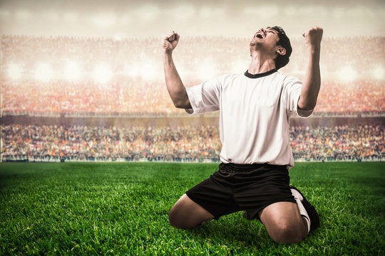 Soccer Football Player Celebrating Goal Scoring In The Stadium