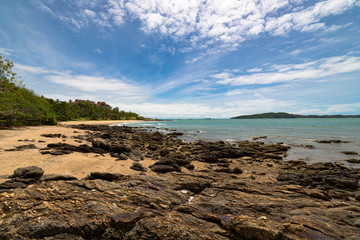 Sea and beach under cloud and blue sky