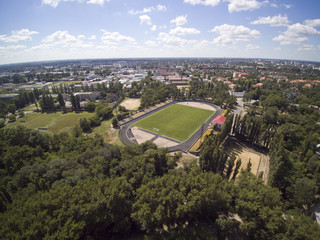 Fototapeta premium Aerial view of the stadium, green football field and the cityview of Nova Kakhovka, Ukraine