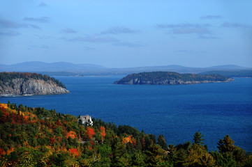 Fototapeta na wymiar autumn forest on islands and blue ocean in Acadia National Park