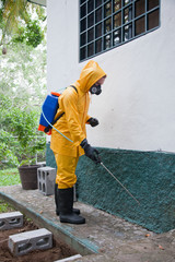 Man fumigating in the garden, exterminator