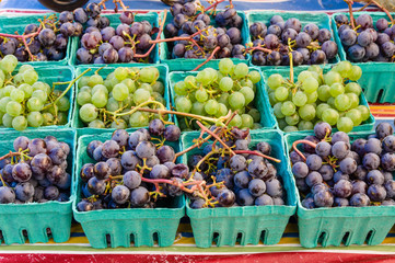 Baskets of fresh grapes at the market