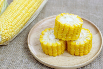 Fresh corn on wood plate