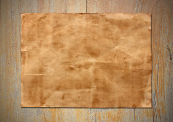 Old paper sheet on old wood background texture
