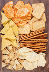 Heap of salted crisps, breadsticks and cookies, concept of unhealthy food