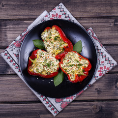 Stuffed red peppers in black plate