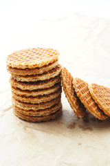 Close up of stack of Dutch caramel waffles on a waxed paper.