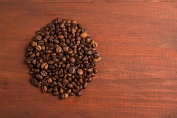 Roasted coffee beans pile from top on the table