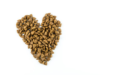 Dried food for dog puppy, with a shape of heart on white background