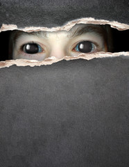 Monster eye in hole in the paper